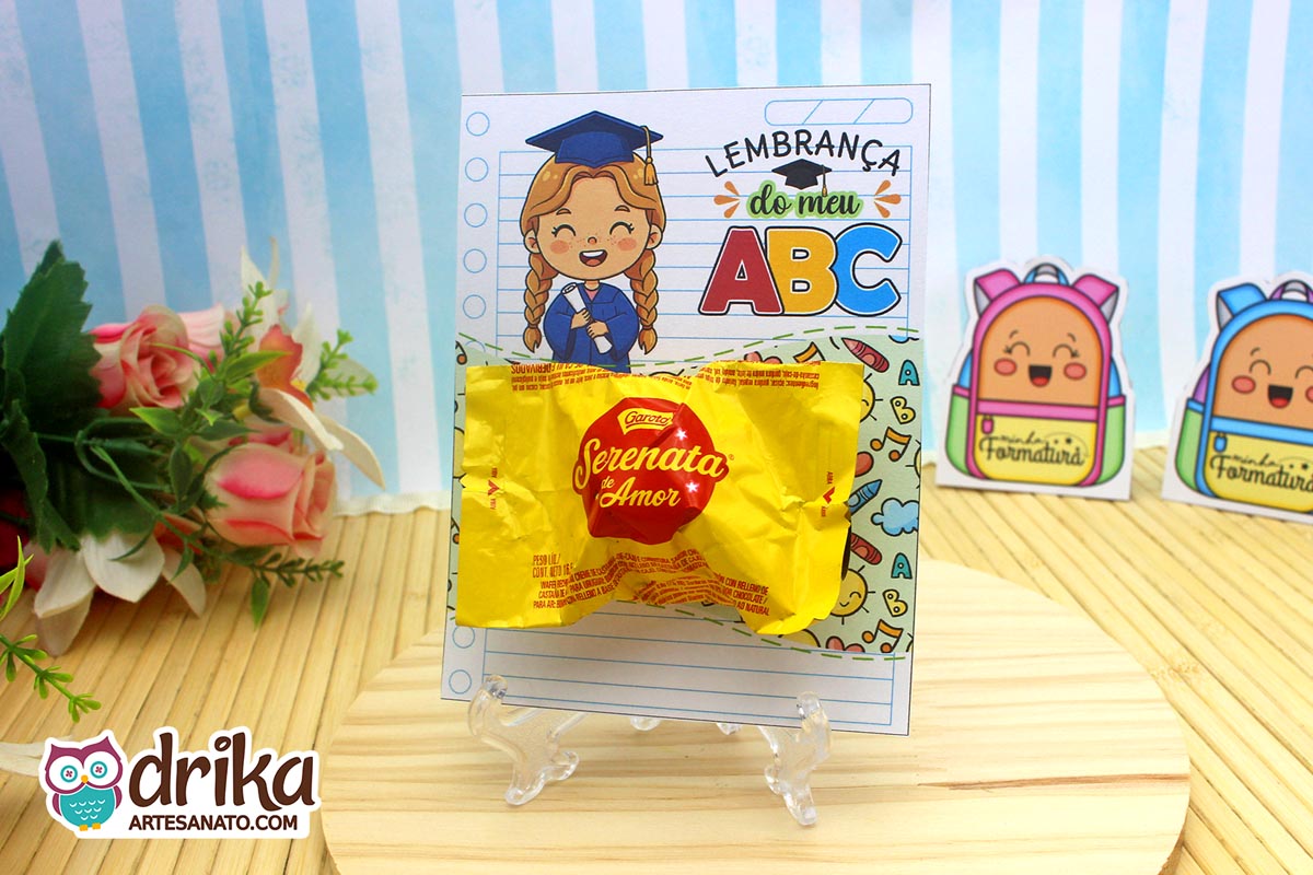 Cartão porta-bombom Formatura ABC com menina de cabelo castanho e bombom Serenata de Amor em suporte de acrílico