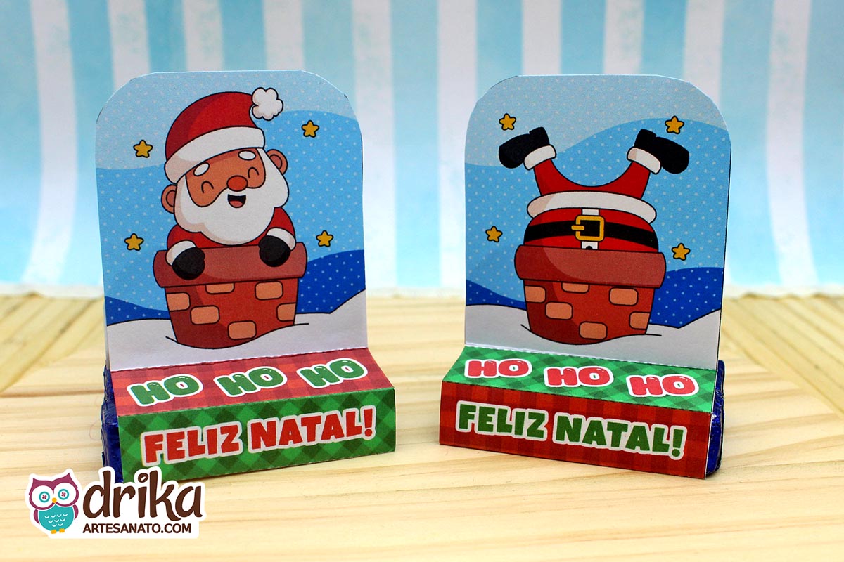 Dois porta-bis duplos de papel: um com Papai Noel de pernas para o ar e outro com Papai Noel sorridente na chaminé