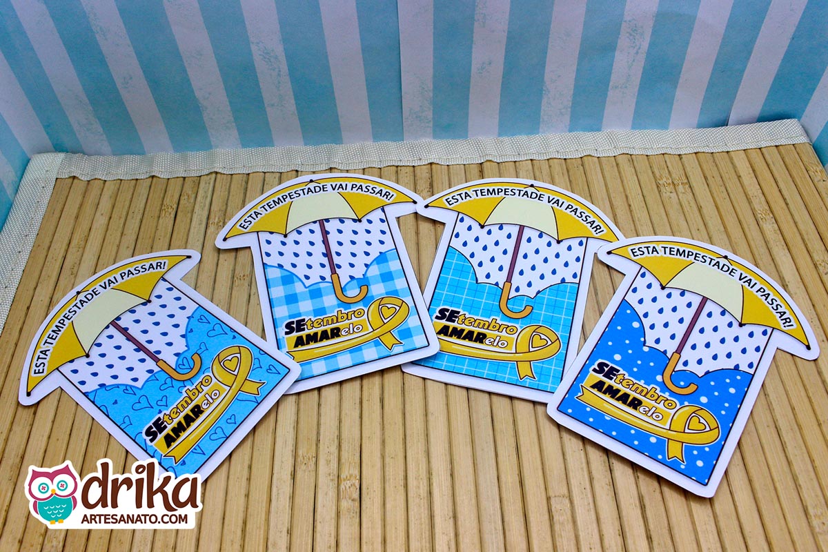 Quatro cartões de papel em formato de guarda-chuva com estampas variadas e a frase Esta tempestade vai passar